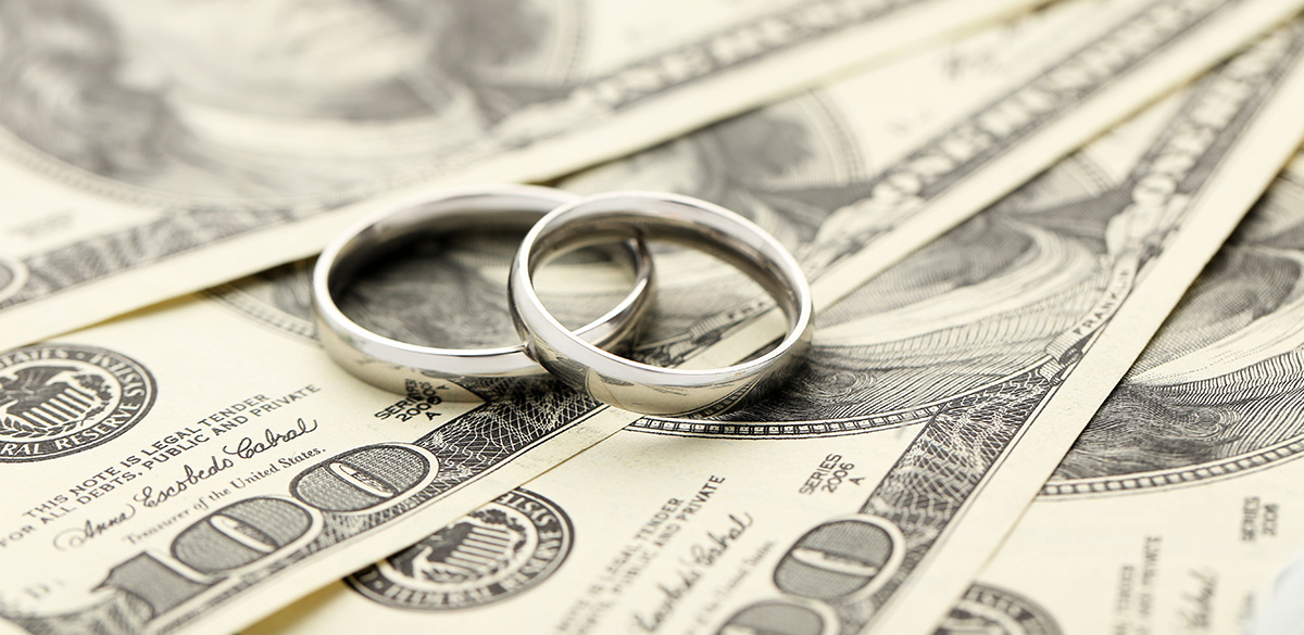 Silver wedding rings on one hundred dollars bill background