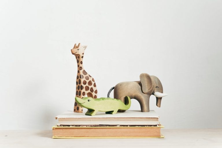 baby animal toys on top of two book